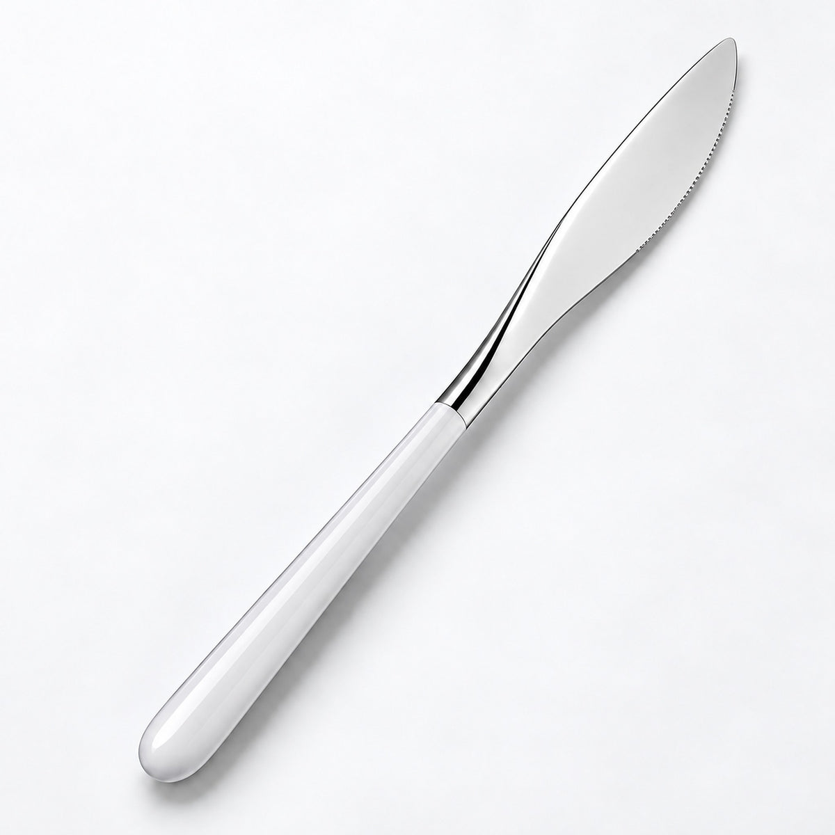 One white and silver dinner knife on a soft studio background.