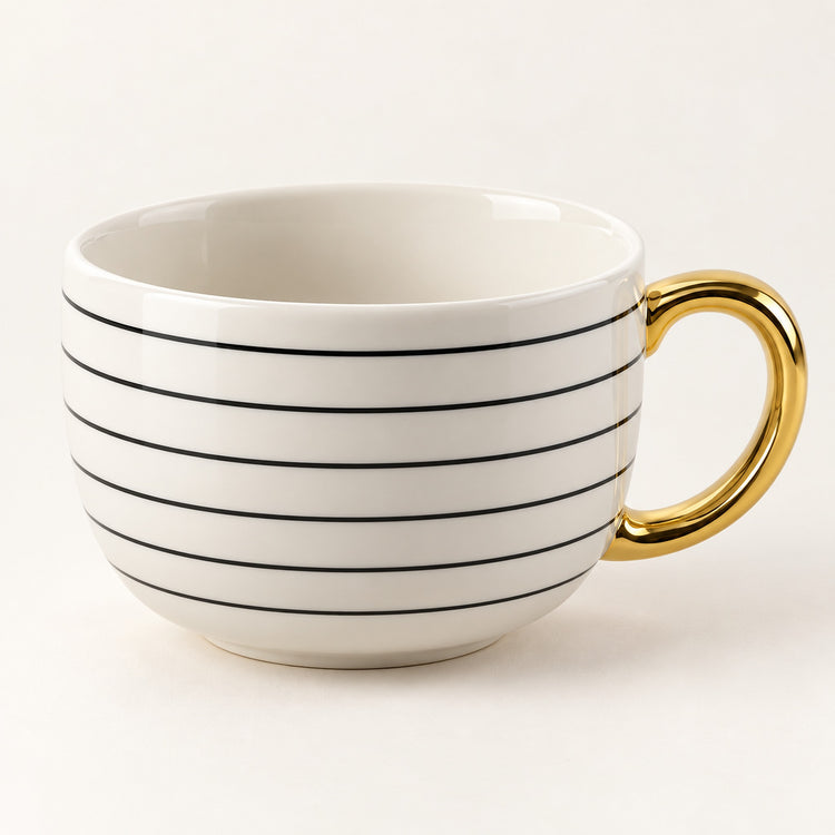 A white ceramic coffee mug with thin black horizontal stripes and a shiny gold handle, shown on a clean off-white background.
