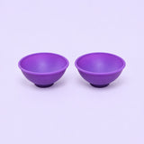 Two purple silicone mini bowls, open tops and pedestal bases.