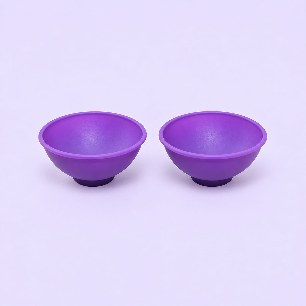 Two purple silicone mini bowls, open tops and pedestal bases.