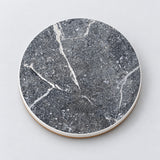One speckled gray and white marble printed ceramic coaster on a light studio background.
