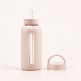 Beige 800 ml glass bottle with silicone sleeve, wide straw and spare loop lid.