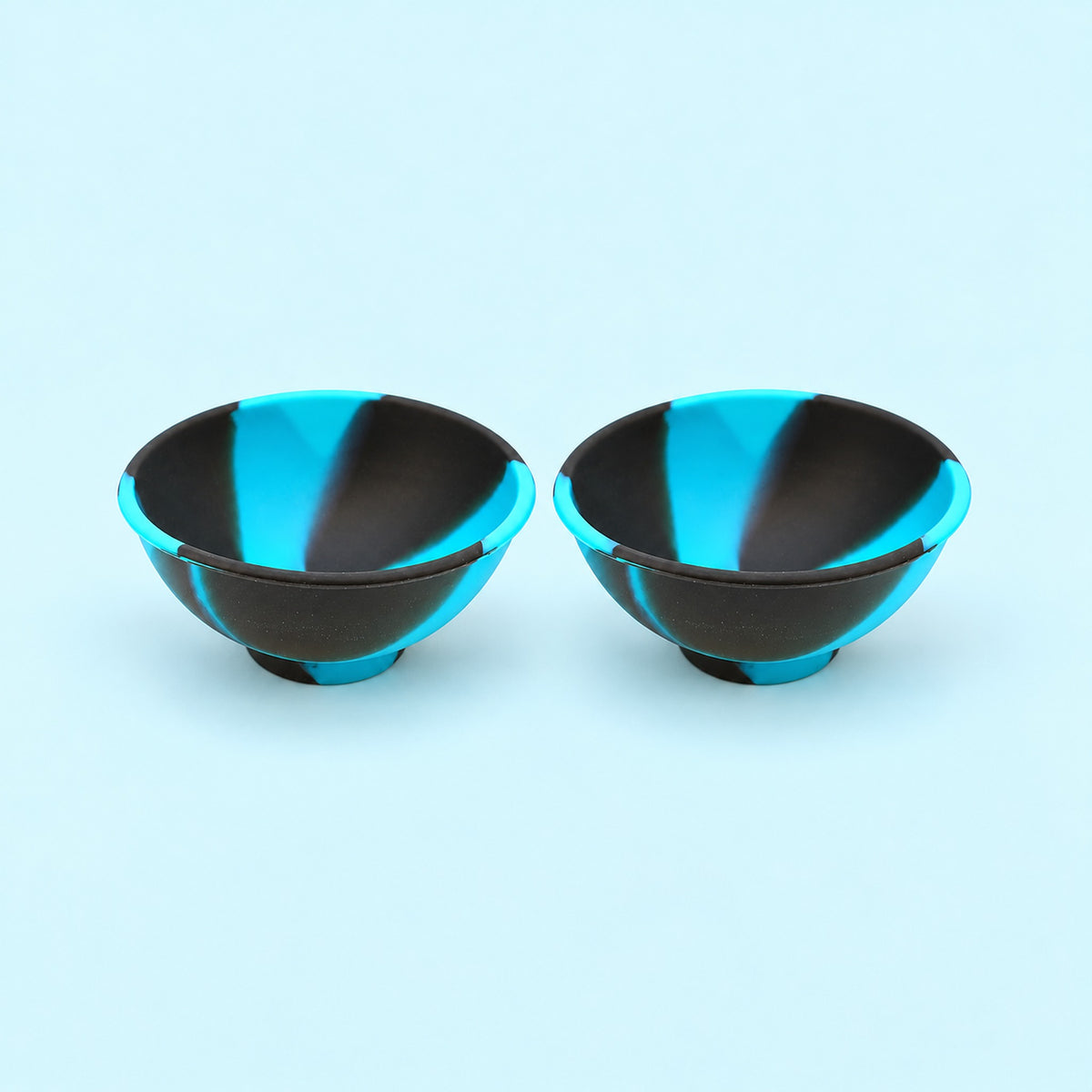 Two black and turquoise swirl silicone mini bowls, open tops and pedestal bases.