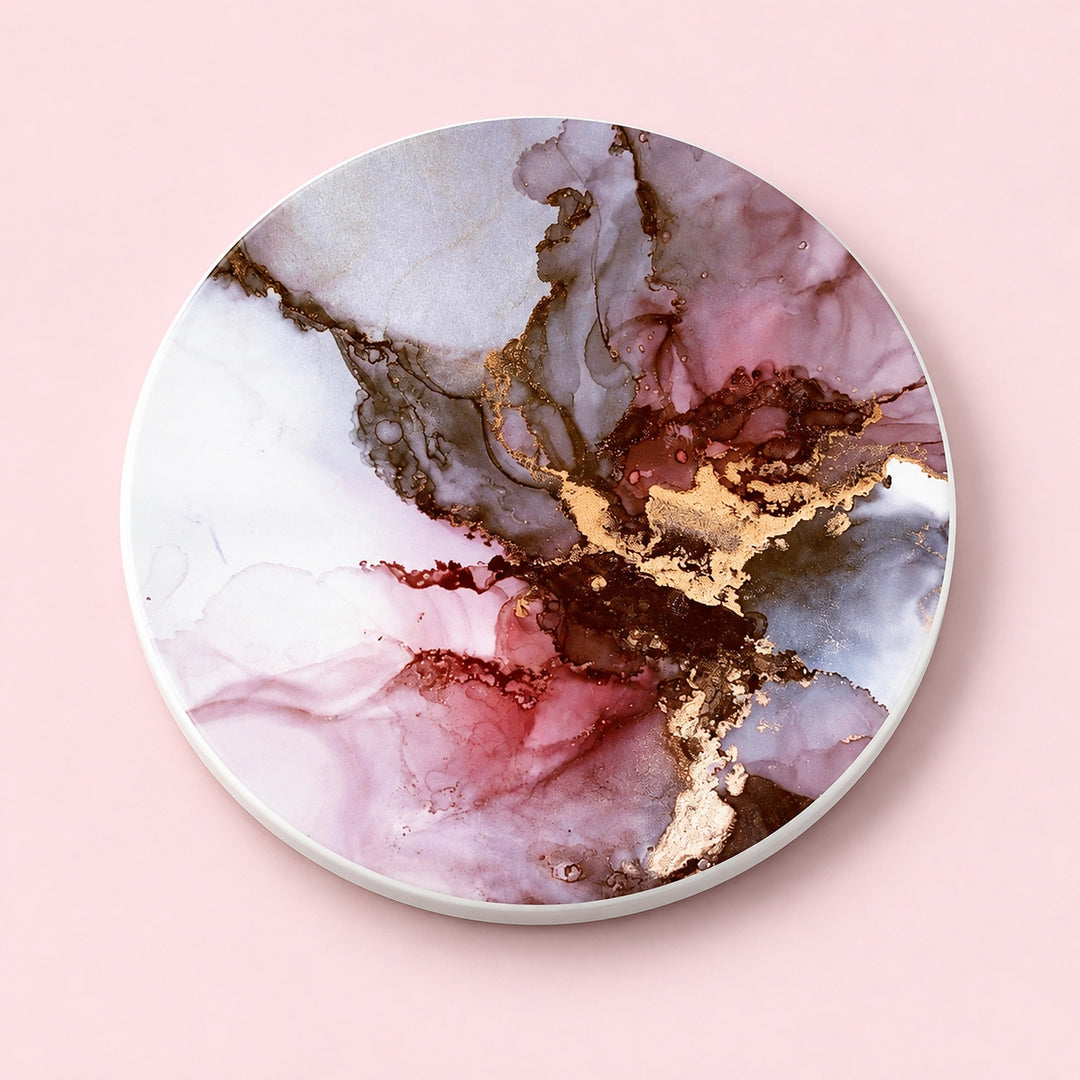 One pink and gold marble printed ceramic coaster on a light studio background.