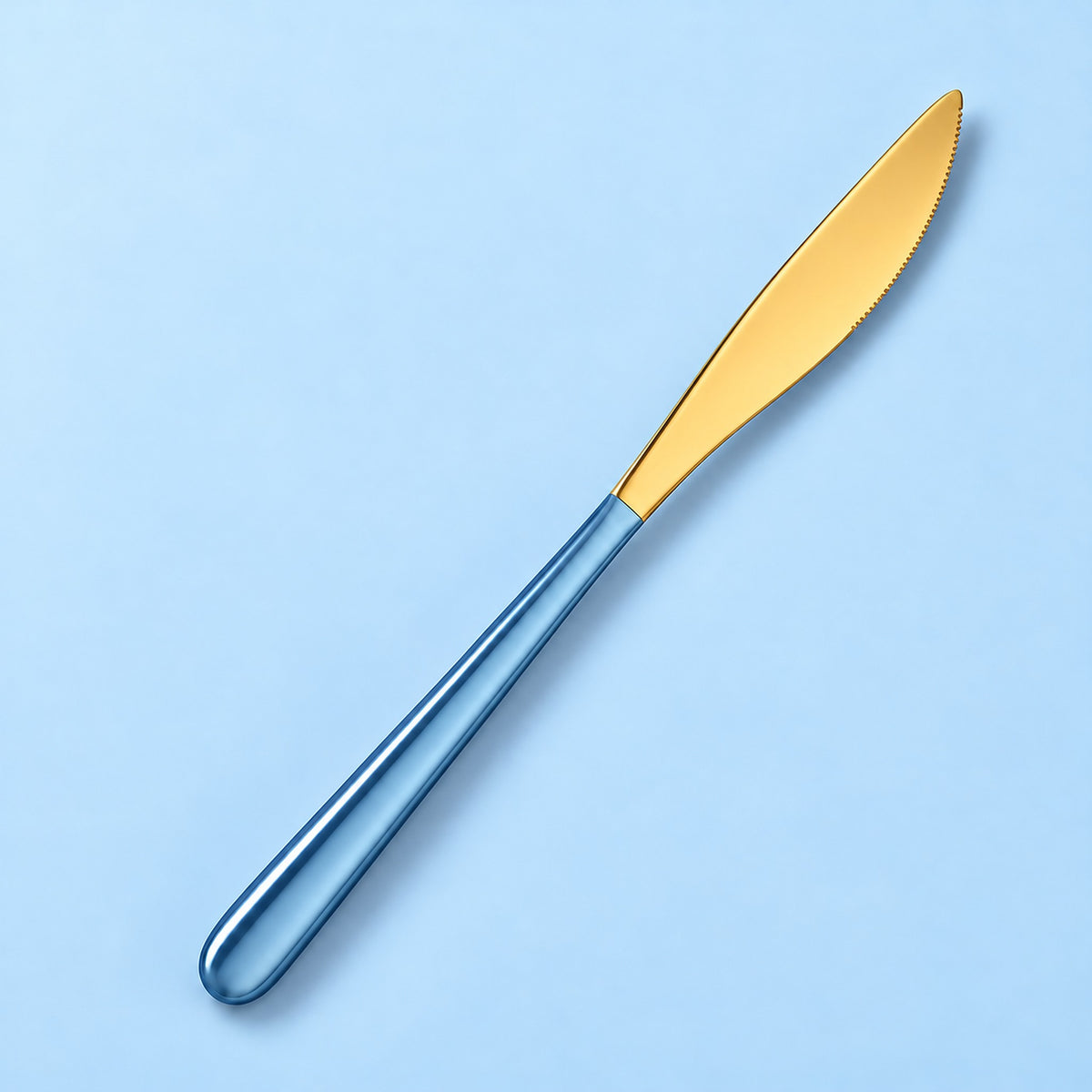 One sky blue and gold dinner knife on a soft studio background.