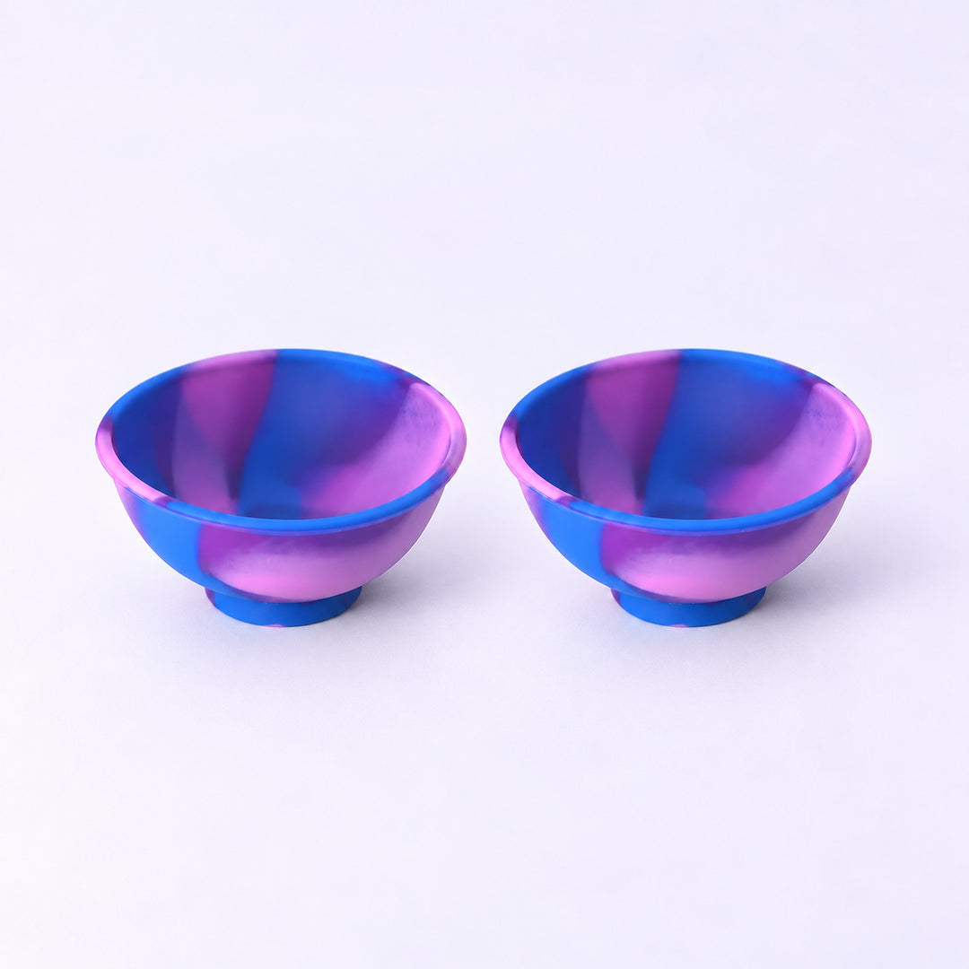 Two blue and purple swirl silicone mini bowls, open tops and pedestal bases.