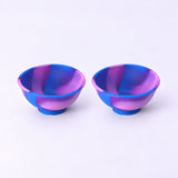 Two blue and purple swirl silicone mini bowls, open tops and pedestal bases.