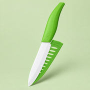 A kitchen knife with a bright green ergonomic handle and matching green sheath, shown floating against a pale green background.