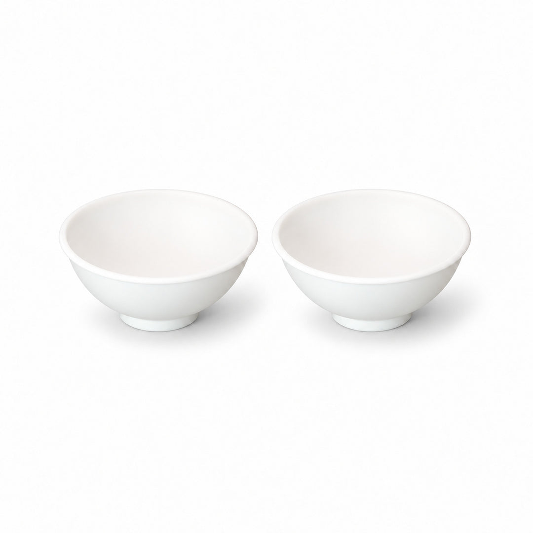 Two white silicone mini bowls, open tops and pedestal bases.