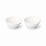 Two white silicone mini bowls, open tops and pedestal bases.
