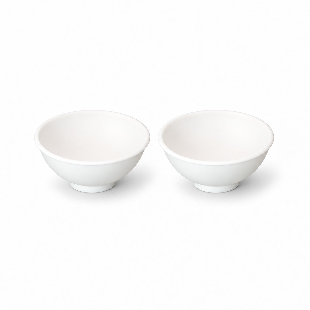 Two white silicone mini bowls, open tops and pedestal bases.