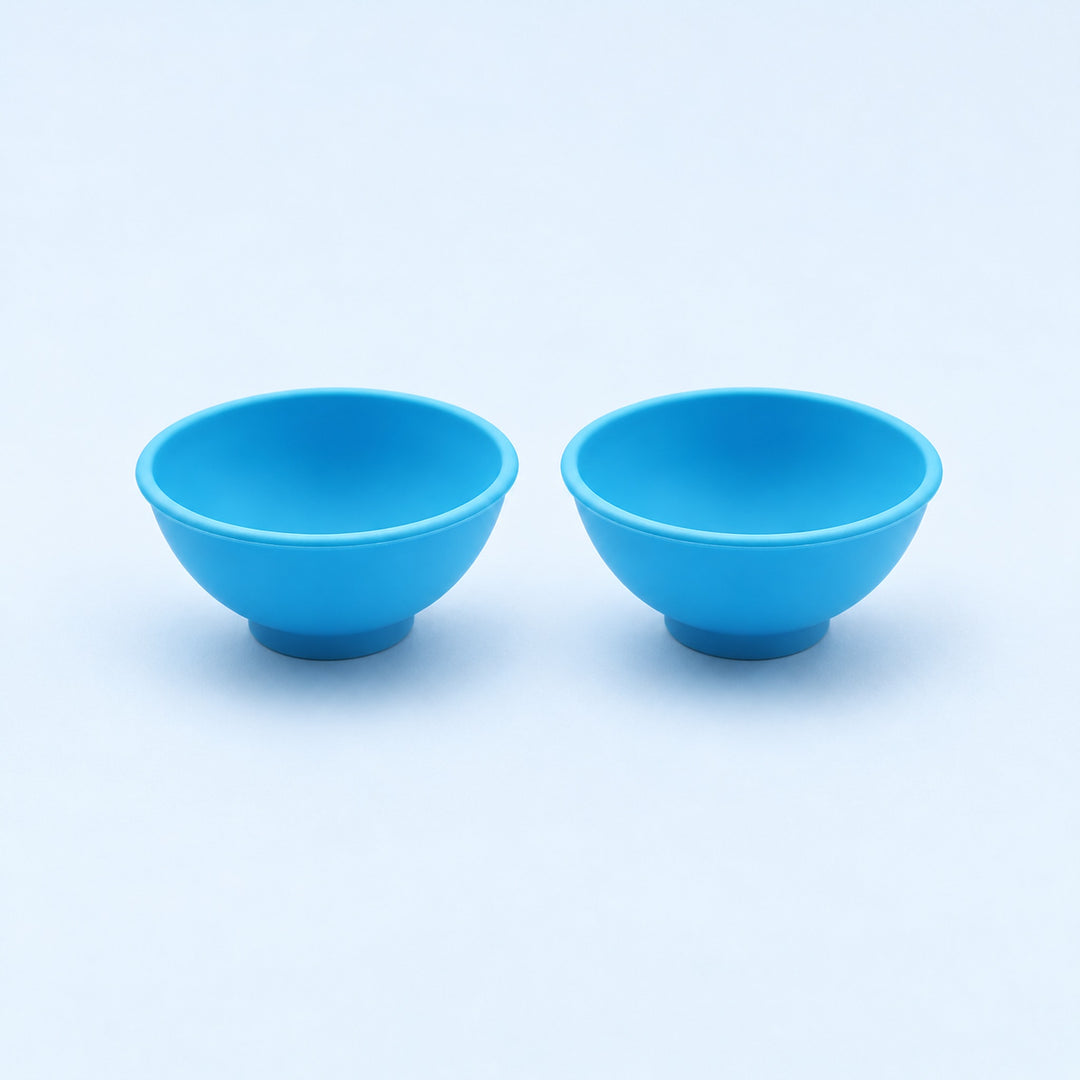 Two blue silicone mini bowls, open tops and pedestal bases.