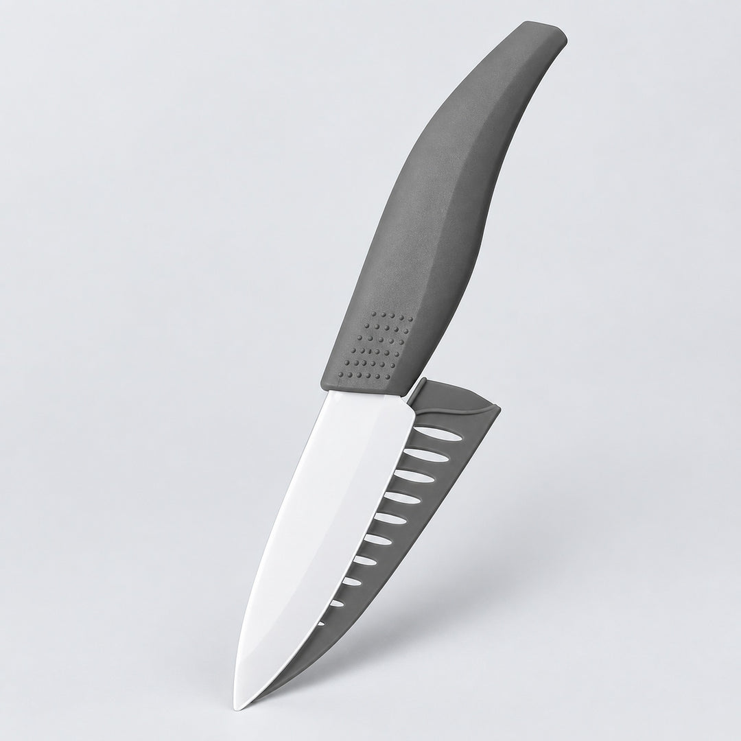A kitchen knife with a matte gray handle and a silver blade featuring a serrated gray edge, shown floating against a light gray background.