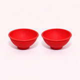 Two red silicone mini bowls, open tops and pedestal bases.