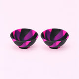 Two black pink and purple swirl silicone mini bowls, open tops and pedestal bases.