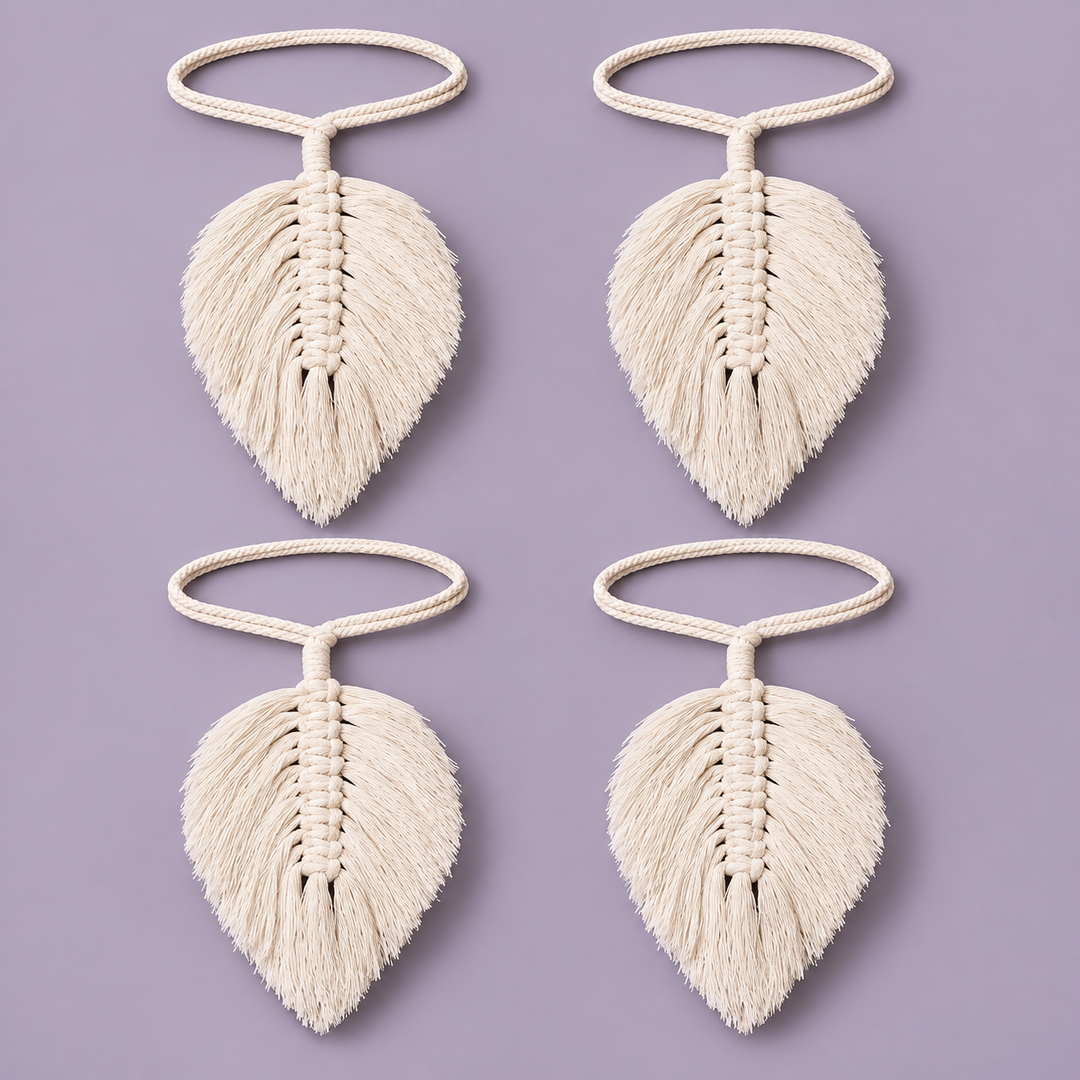 Four cream-colored macrame leaf keychains arranged in a 2x2 grid on a solid lavender background.