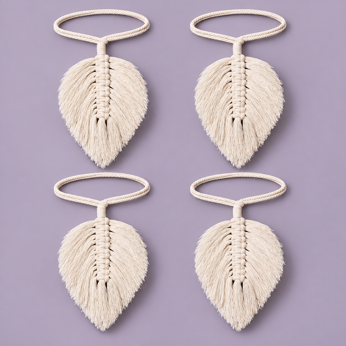 Four cream-colored macrame leaf keychains arranged in a 2x2 grid on a solid lavender background.
