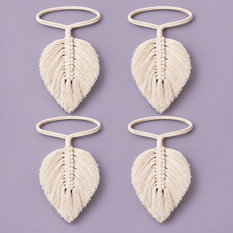 Four cream macrame leaf curtain tie backs on cord loops against a lilac ground