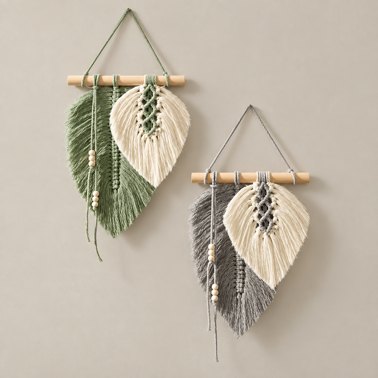 Green and grey macrame leaf hangings at two sizes on a neutral wall