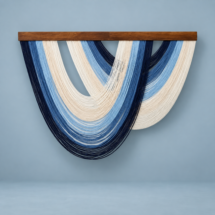 Navy and mid blue nested arc wall hanging on a soft blue background