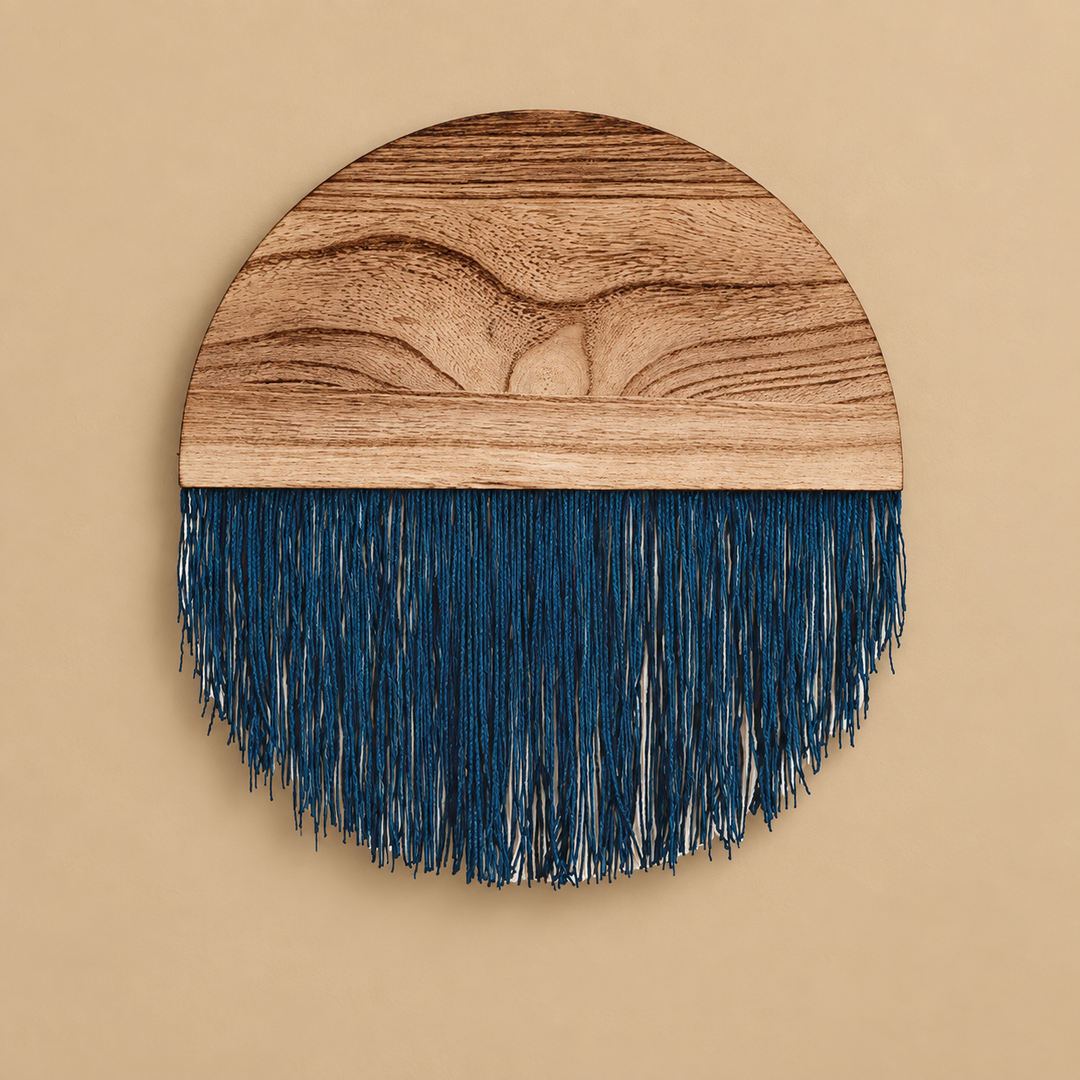 Deep indigo fringe under a grained wood half disc forming a circle on a sand wall
