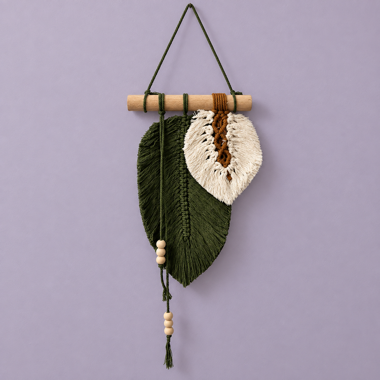 Forest green and cream macrame leaf with beaded cord on a lilac background