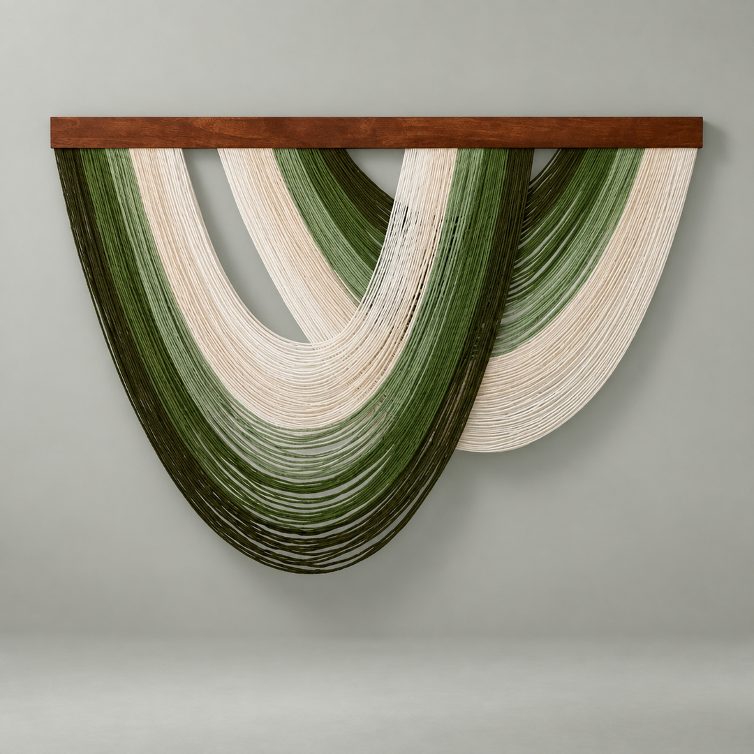 Olive and cream nested arc wall hanging under a dark batten on a cream wall