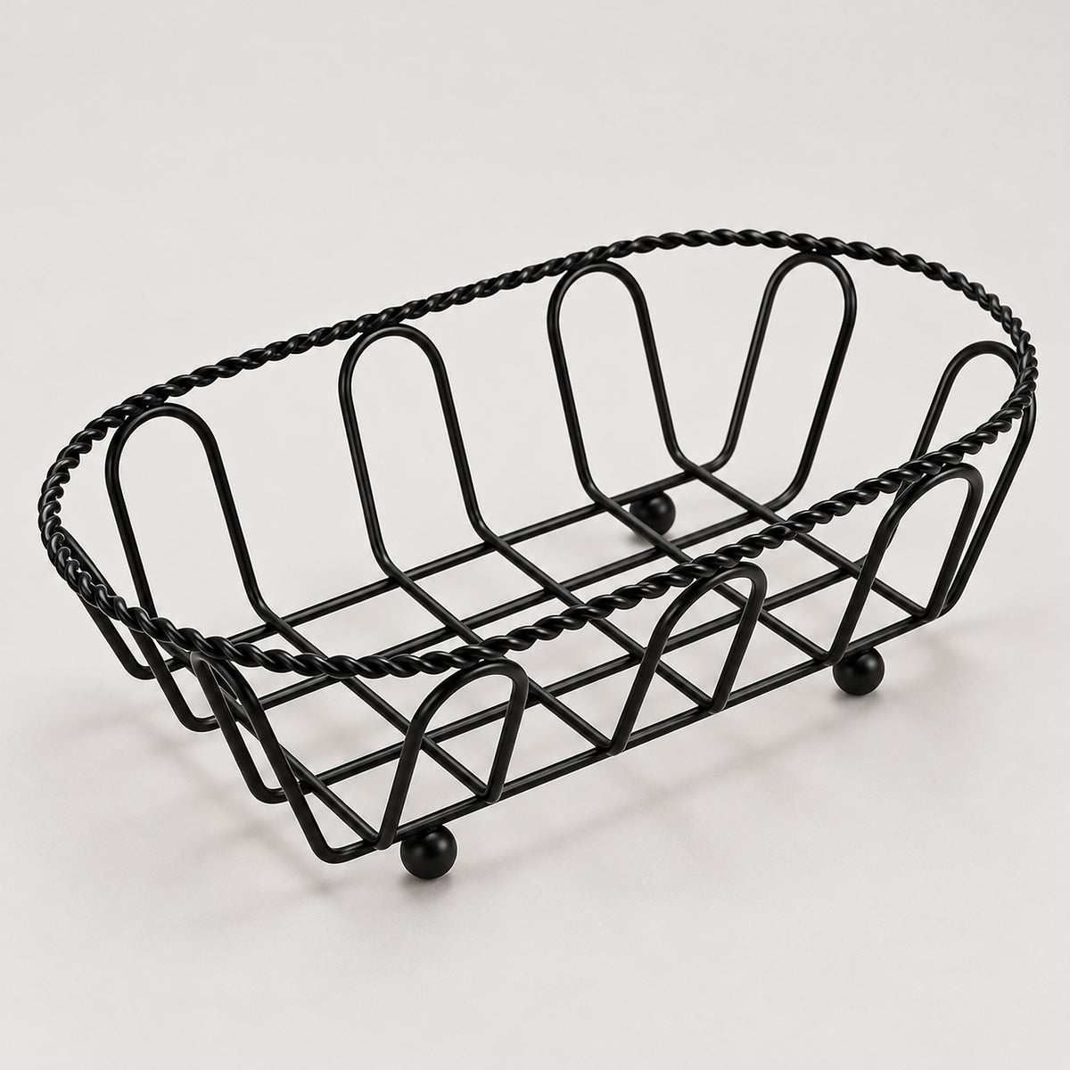 Oval black wire serving basket with twisted rim and small feet, 19 cm long.