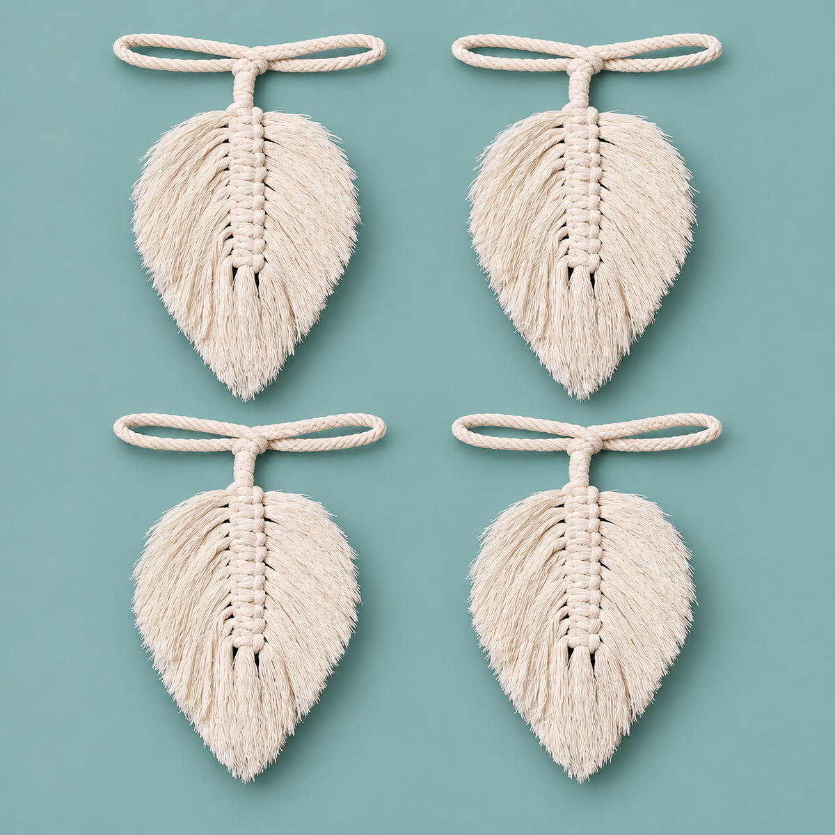 Four identical cream-colored macrame leaf ornaments with hanging loops, arranged in a 2x2 grid on a solid teal background.