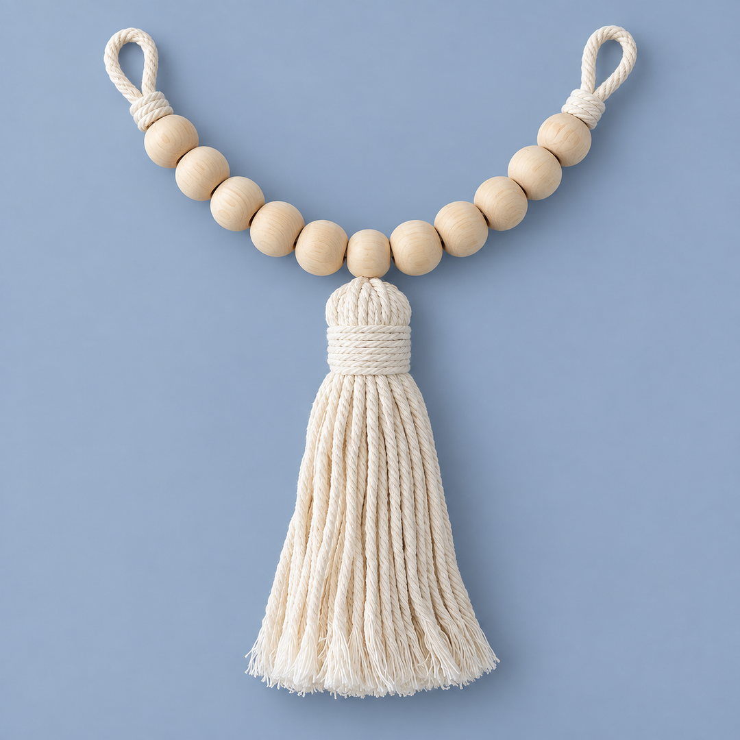 Single beaded cotton curtain tie back with a thick cream tassel on a blue background