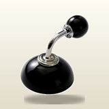 A black and silver car gear shift knob with a glossy finish, shown against a light beige gradient background.