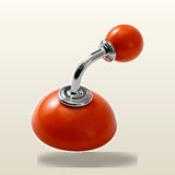 A glossy orange car gear shift knob with a curved chrome metal stem and matching orange ball end, shown on a light beige gradient background.