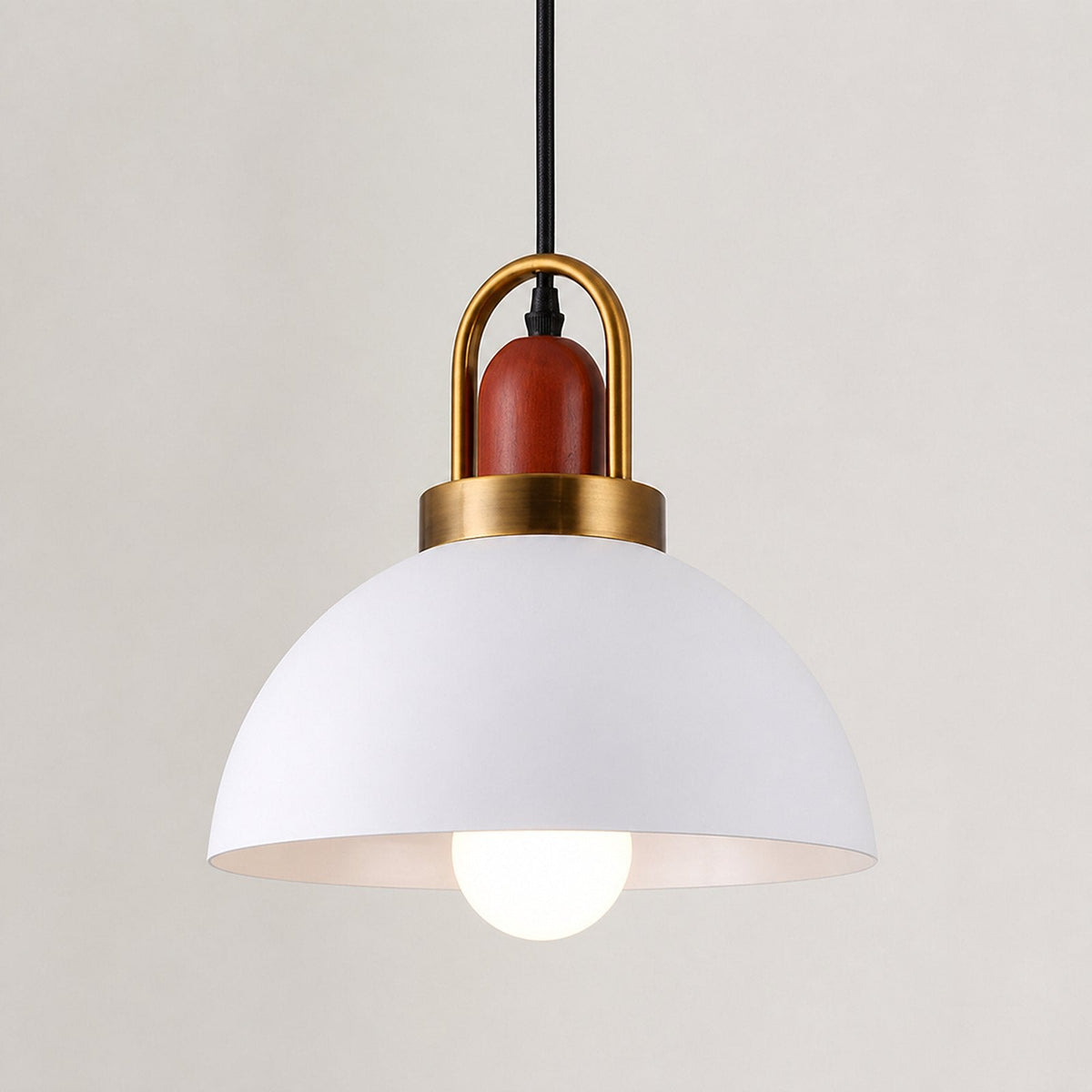 A modern pendant light with a matte white dome shade, a polished gold metal U-shaped frame, and a reddish-brown cylindrical accent on the cord, shown against a plain light beige background.